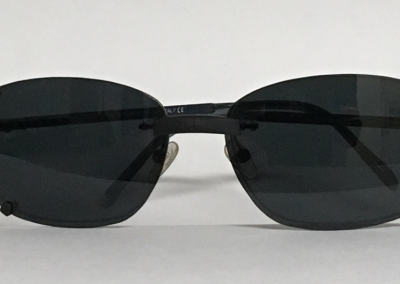 Magnetic clip-on sunglasses over rimless spectacles