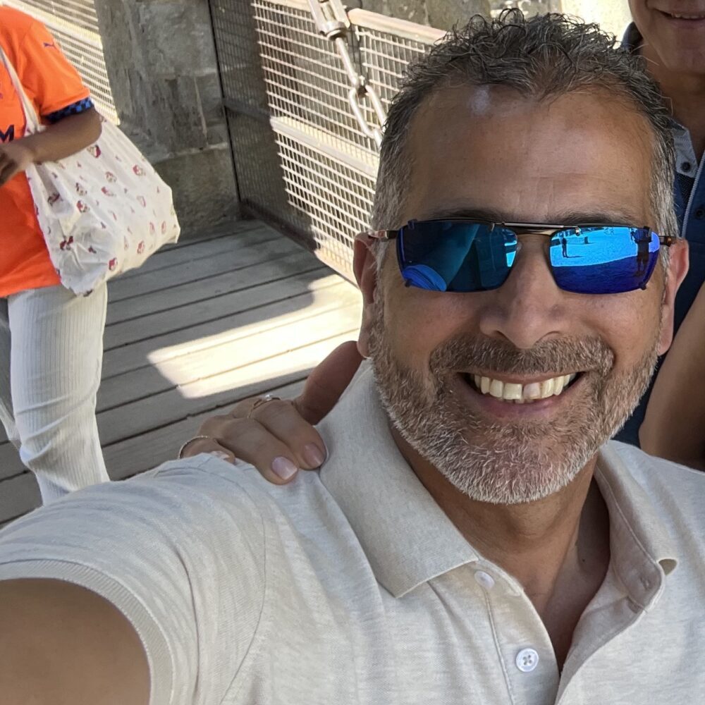 man wearing Oakley glasses with matching clip on sunglasses